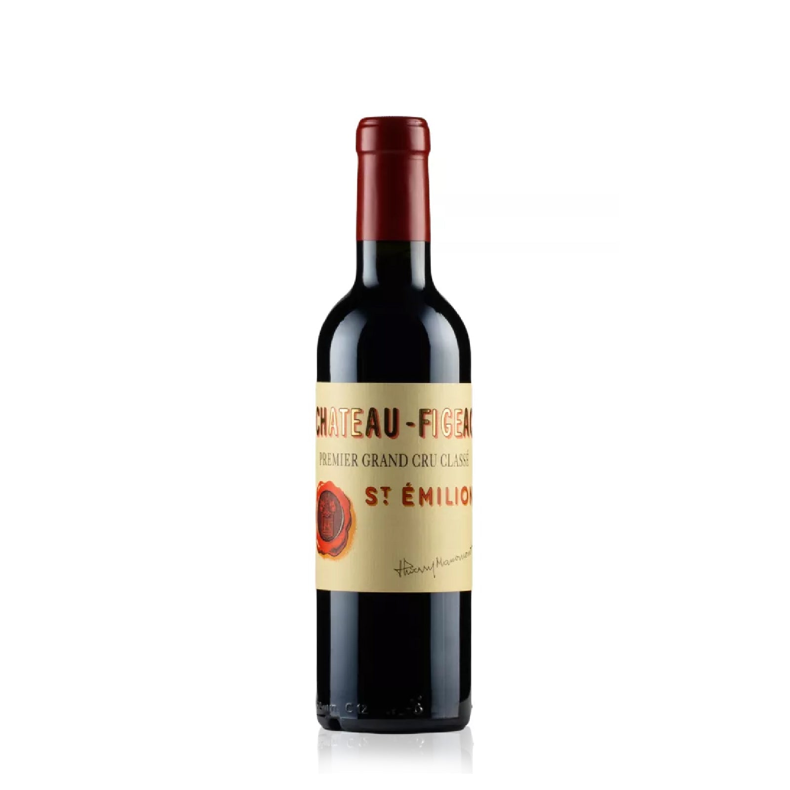 Red wine half bottle with a Chateau Figeac label on a white background