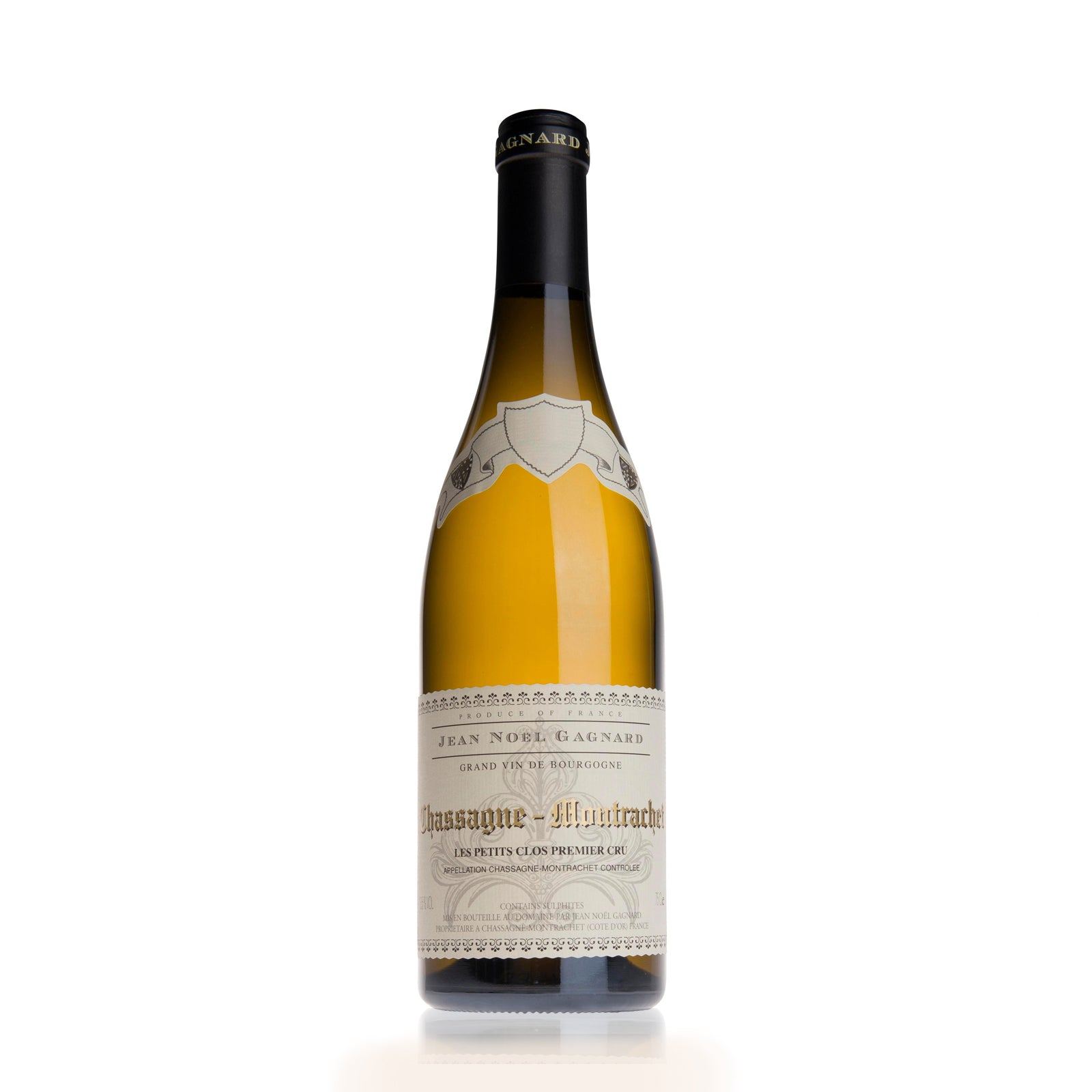 Bottle of Domaine Jean Noel Gagnard Chassagne-Montrachet Les Petit Clos Premier Cru white wine with a beige label, predominantly displayed against a plain background.