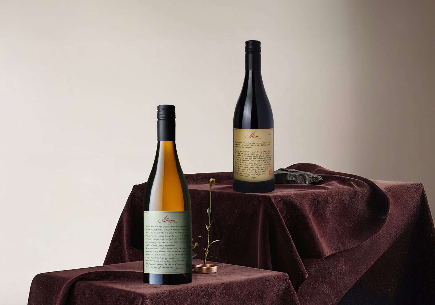 Two wine Lethbridge bottles on a draped table with a neutral background