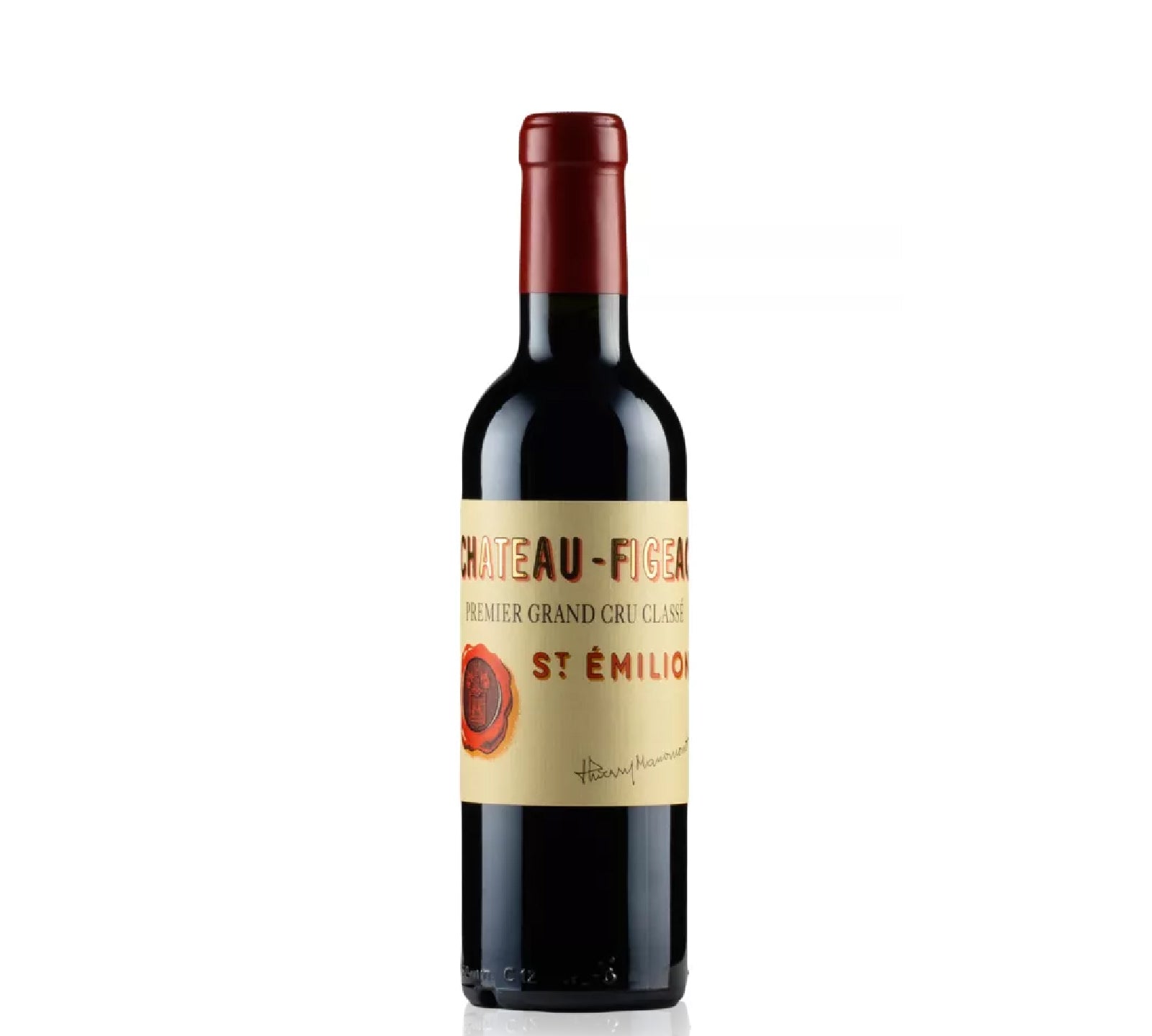 Red wine half bottle with a Chateau Figeac label on a white background