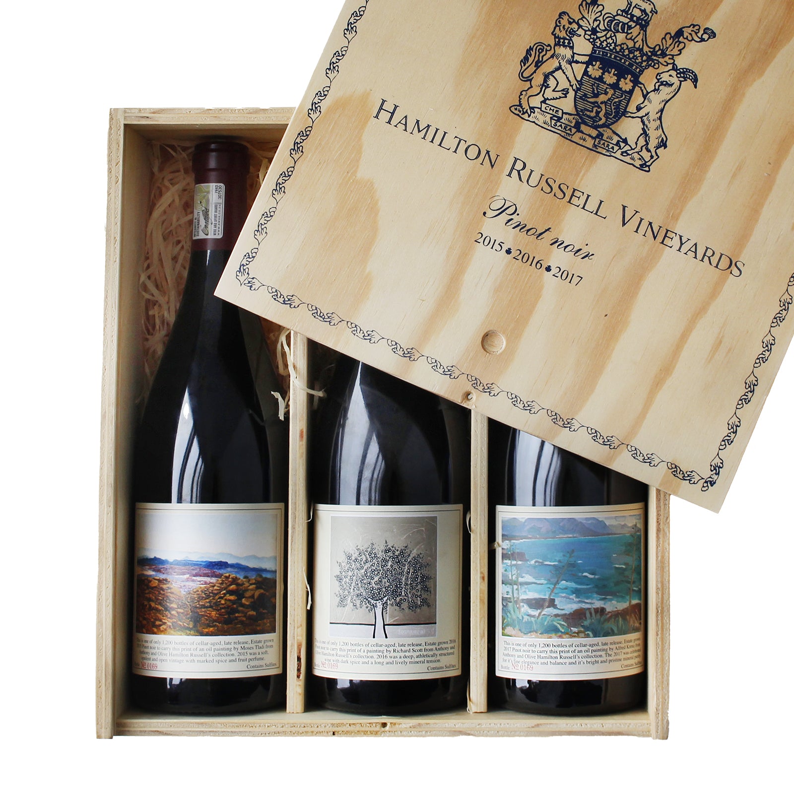 A case of three bottles of Hamilton Russell Vineyards Pinot Noir wine, with each bottle in its own compartment, displayed with the wooden lid open.