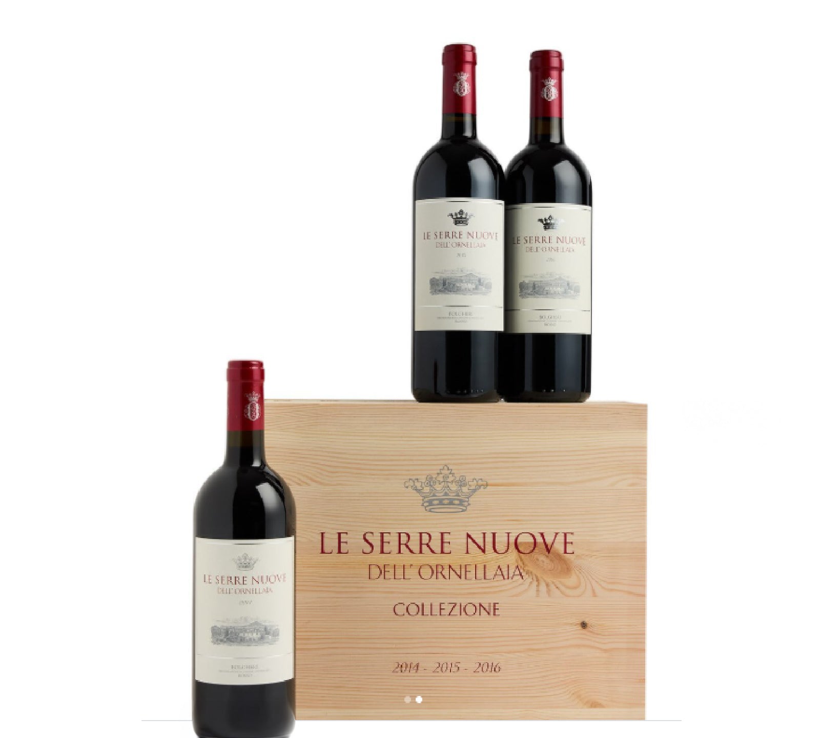 Three bottles of Le Serre Nuove wine in a wooden box on a white background
