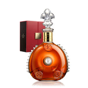 Luxury cognac bottle with decorative cap and red box on a white background