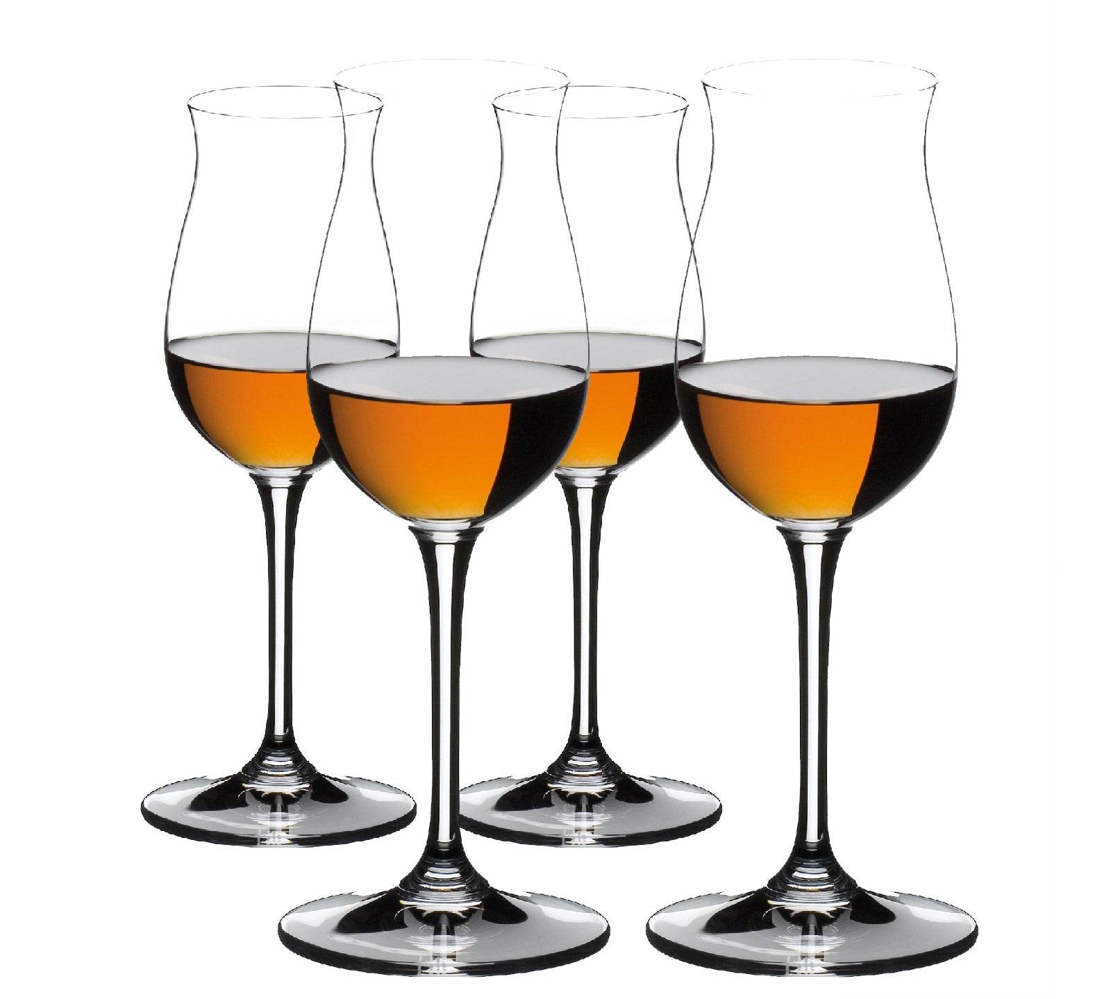 A set of four clear crystal glasses with a narrow neck and a wide base, filled with amber-colored liquid, presumably cognac.
