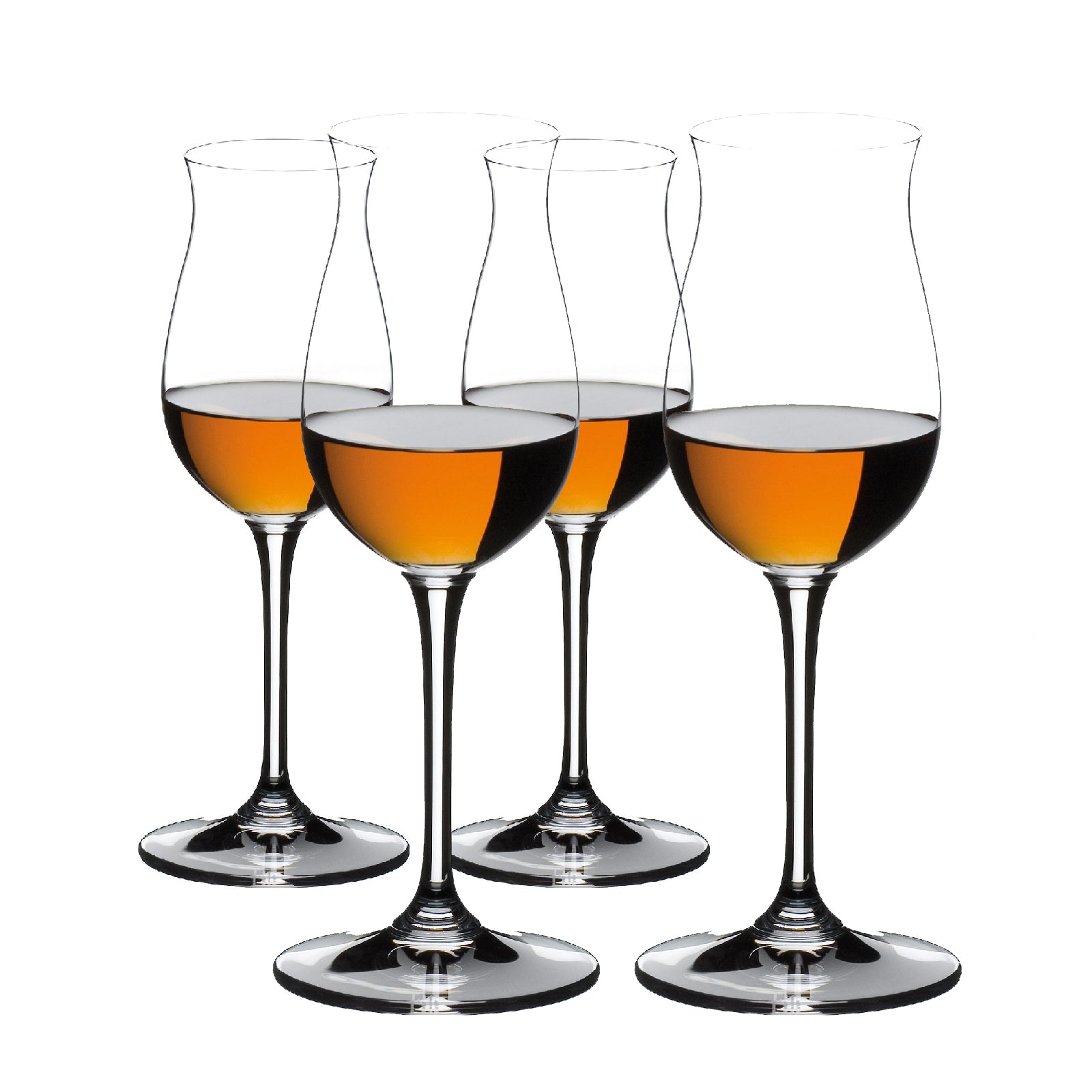 A set of four clear crystal glasses with a narrow neck and a wide base, filled with amber-colored liquid, presumably cognac.
