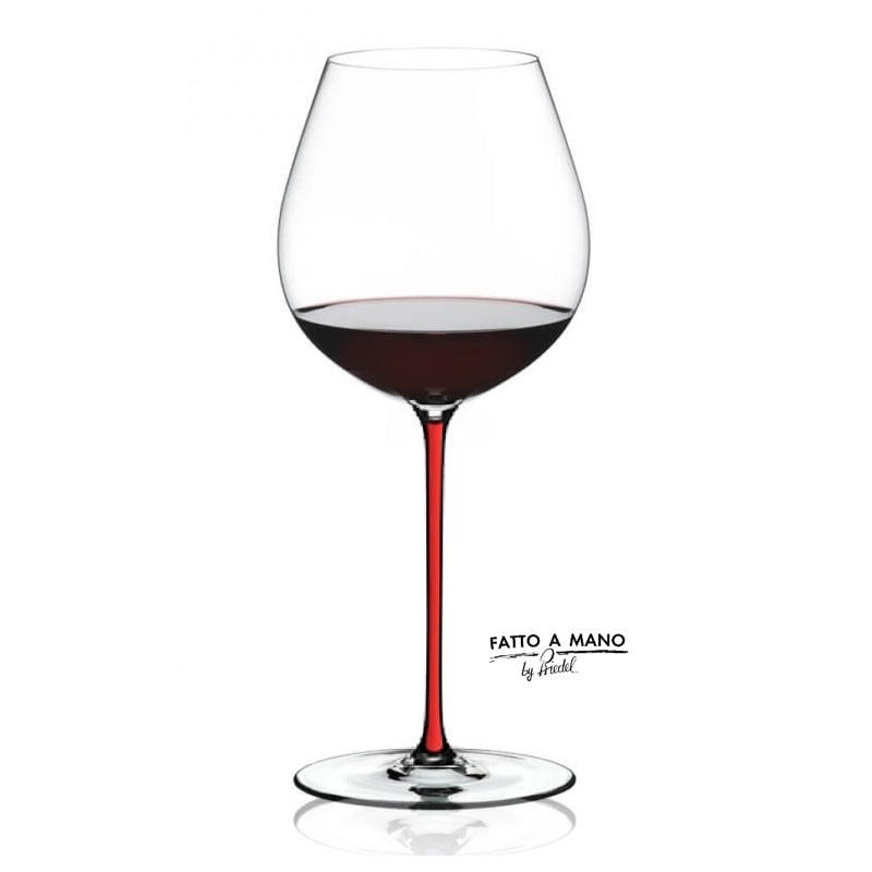 Wine glass with red wine and 'Fatto a Mano' branding on a white background
