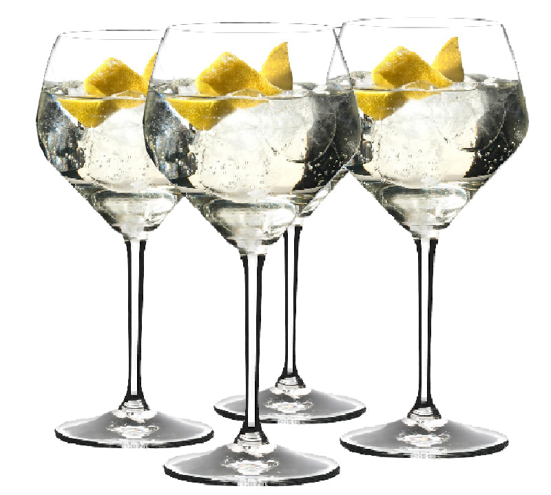A set of four Riedel glasses with a tulip-shaped design, filled with water and a slice of lemon, showcasing their large bowls and slender stems.