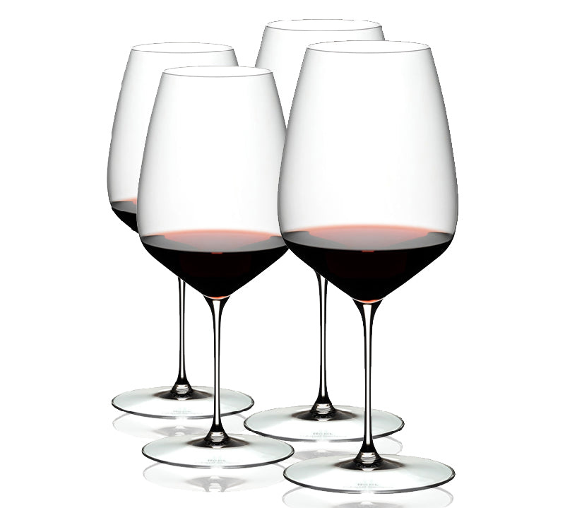 A set of four clear RIEDEL Veloce Cabernet Sauvignon wine glasses filled with red wine, showcasing their slender stems and rounded bowls.