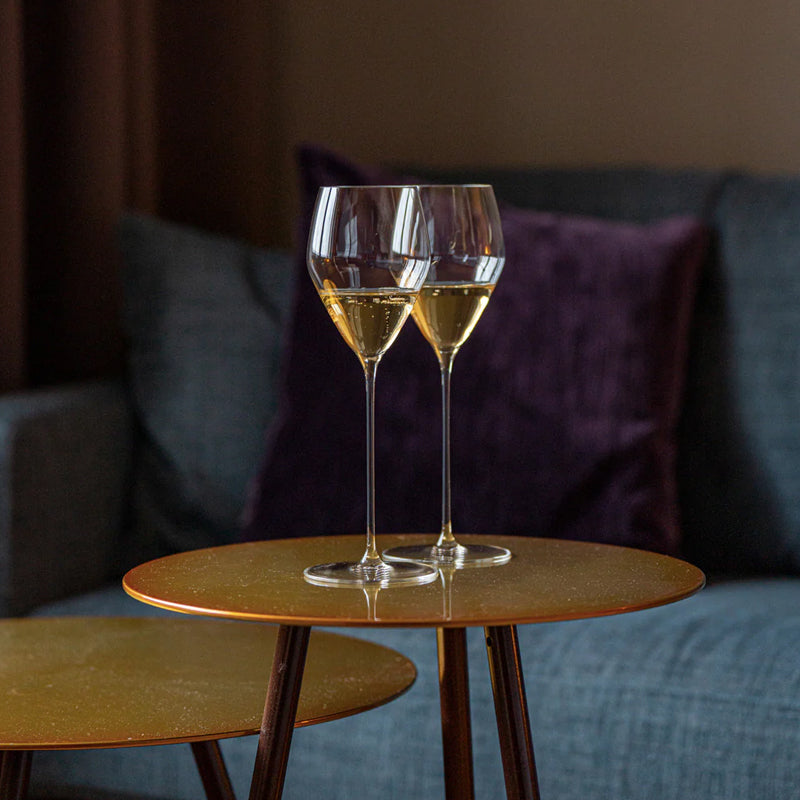 A set of two clear crystal RIEDEL Veloce champagne glasses with long stems and flared bowls
