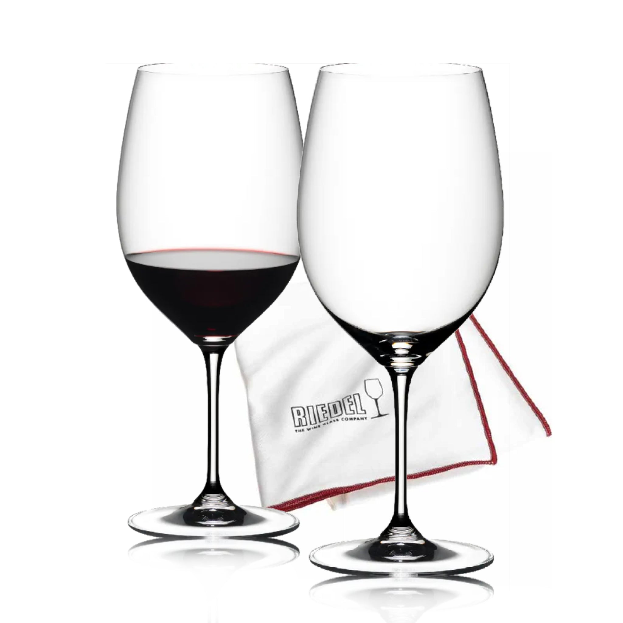 Two wine glasses with red wine and a Riedel branded cloth on a white background