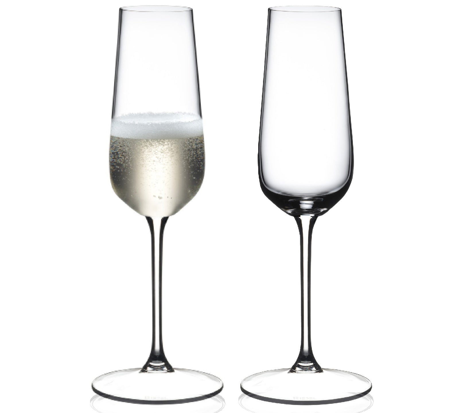 Two champagne flutes with one containing a small amount of champagne on a white background, featuring the Riedel brand.