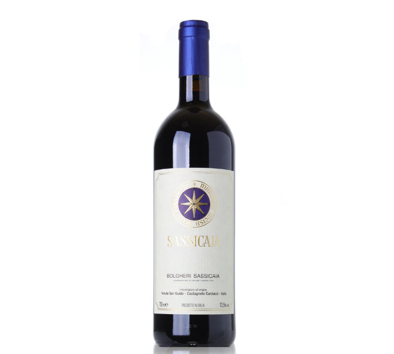 A bottle of Tenuta San Guido Sassicaia red wine with a label featuring a gold star, against a white background.