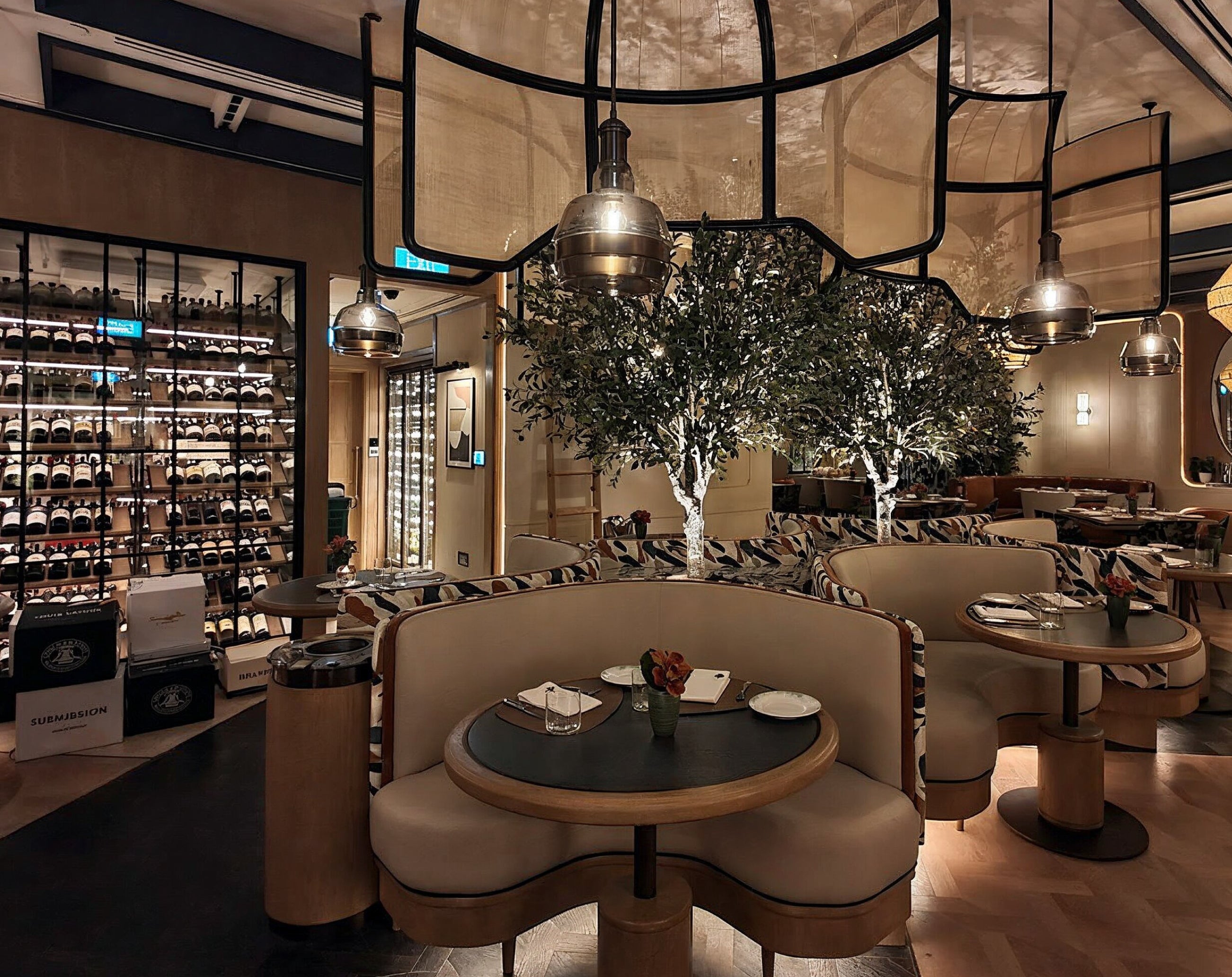 Modern restaurant interior with tables, chairs, and wine bottles.