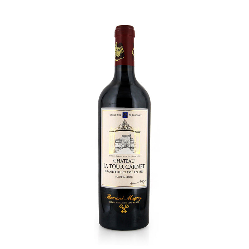 A bottle of Chateau La Tour Carnet Haut-Medoc wine with a label that includes an illustration of the chateau and text indicating the wine's appellation and vintage.