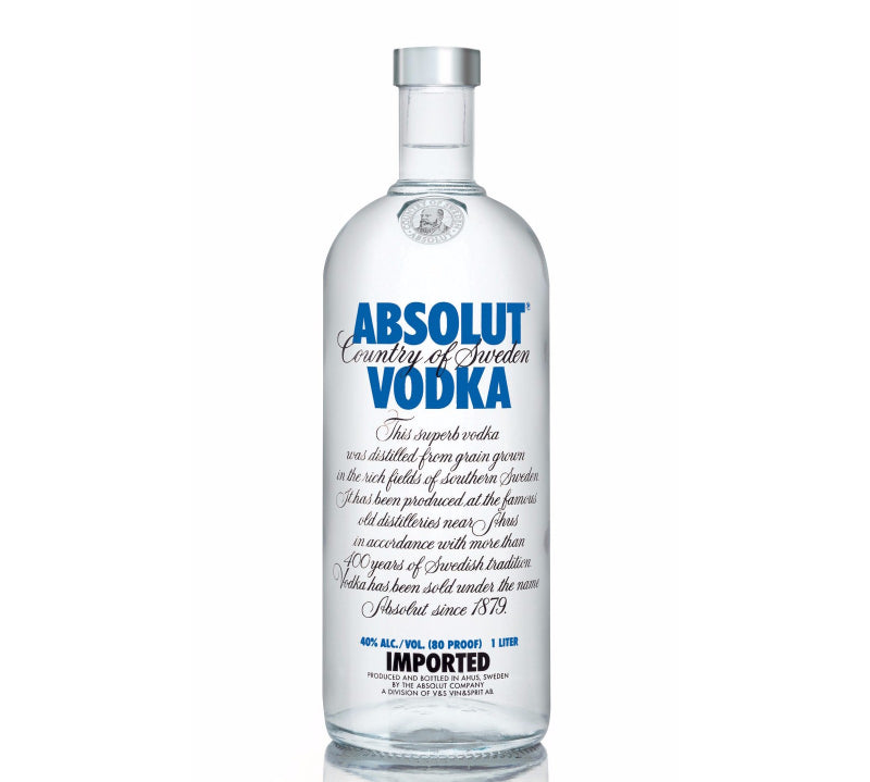 A clear glass bottle of Absolut Vodka with a blue label.