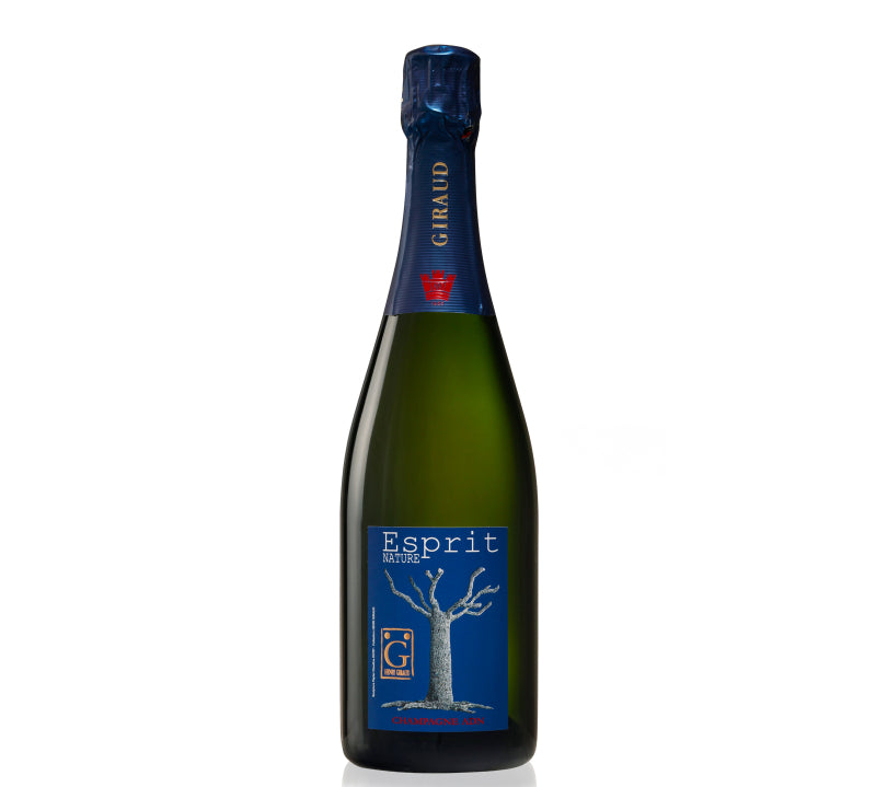 A bottle of Henri Giraud Champagne Esprit Nature with a label featuring a tree, indicating it is a product of the Champagne region.