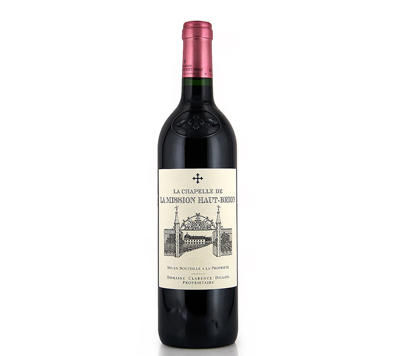 A bottle of La Chapelle de La Mission Haut Brion Pessac-Leognan red wine with a label depicting an illustration of a building.