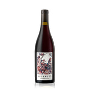 Bottle of Saurwein Nom Pinot Noir wine with a label featuring a floral design.