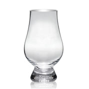 A clear, round-bottomed, stemless whisky glass with a tapered mouth, on a white background.