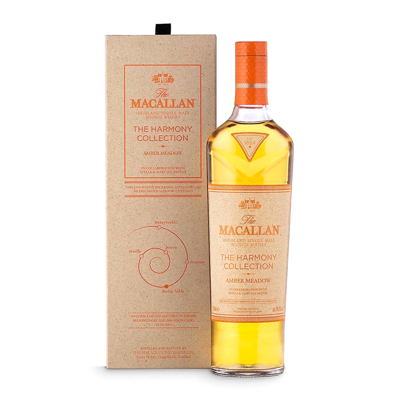 The image shows a bottle of The Macallan The Harmony Collection III Amber Meadow, accompanied by its packaging. The bottle has a amber-colored liquid and a orange label, while the box is beige with text and decorative elements.